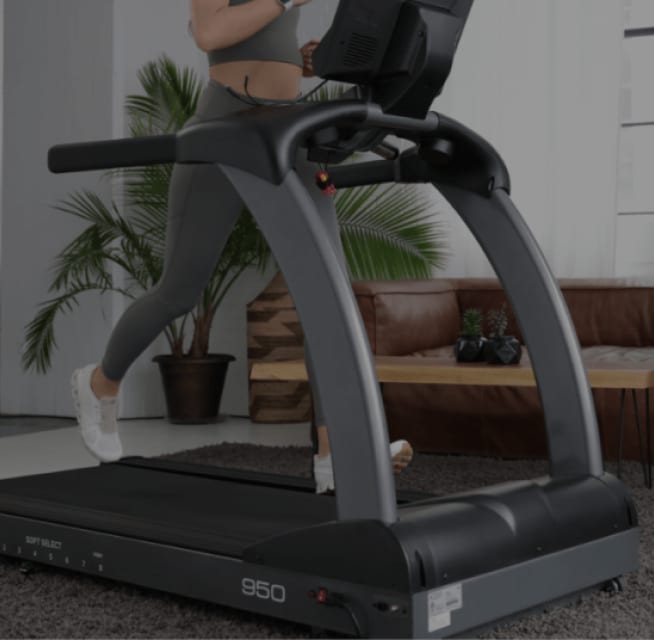 Woman running on a TRUE treadmill at home.